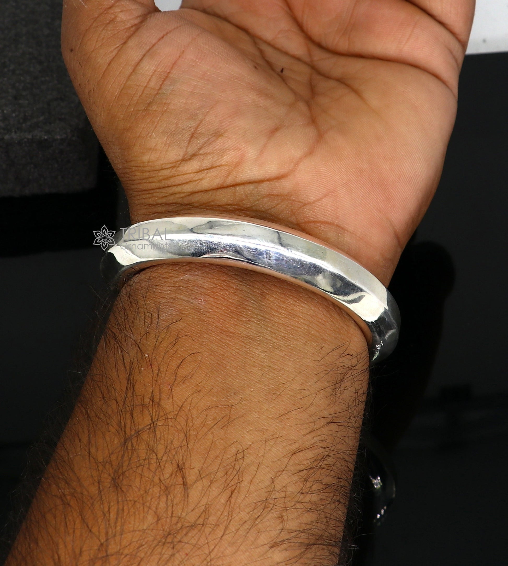 Sterling silver 12mm shiny bangle bracelet by Tribal Ornaments, unisex handmade jewelry with a smooth, polished finish.