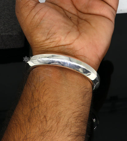 Sterling silver 12mm shiny bangle bracelet by Tribal Ornaments, unisex handmade jewelry with a smooth, polished finish.