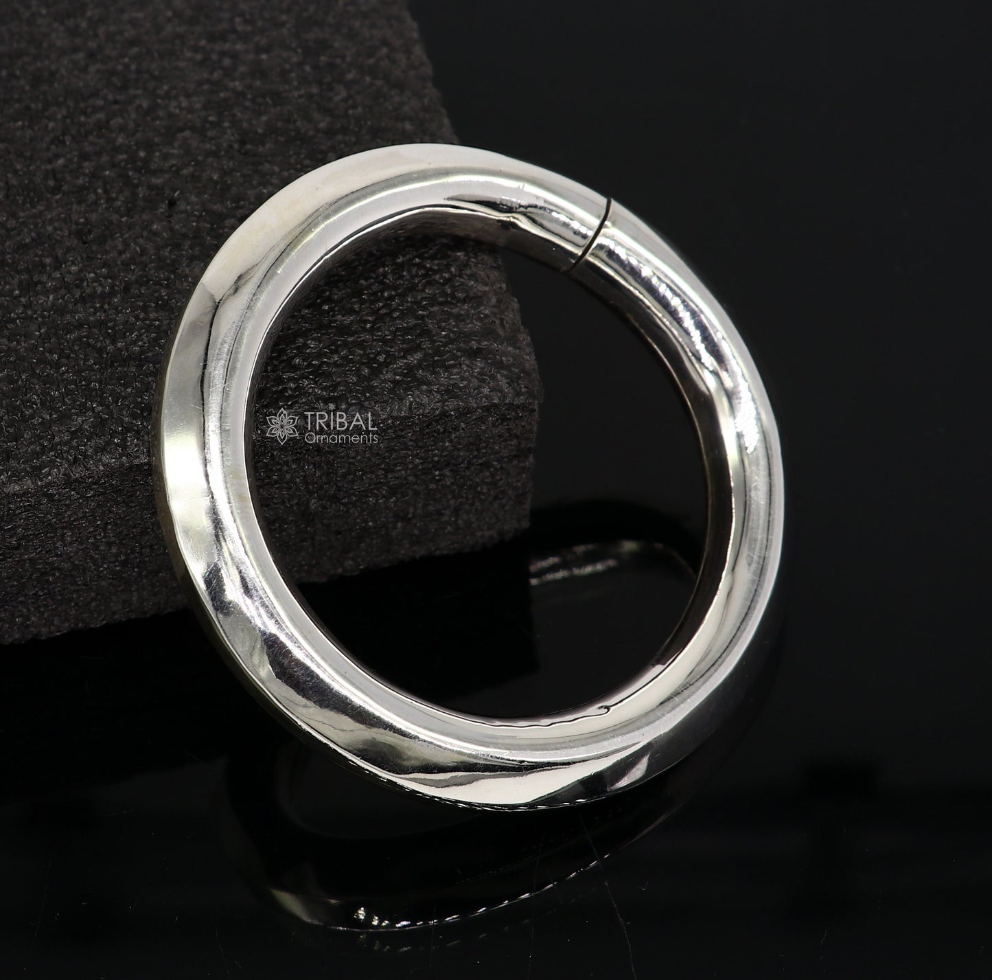 Sterling silver 12mm shine bright bangle bracelet by TRIBAL ORNAMENTS, unisex handmade jewelry with a smooth, polished finish.