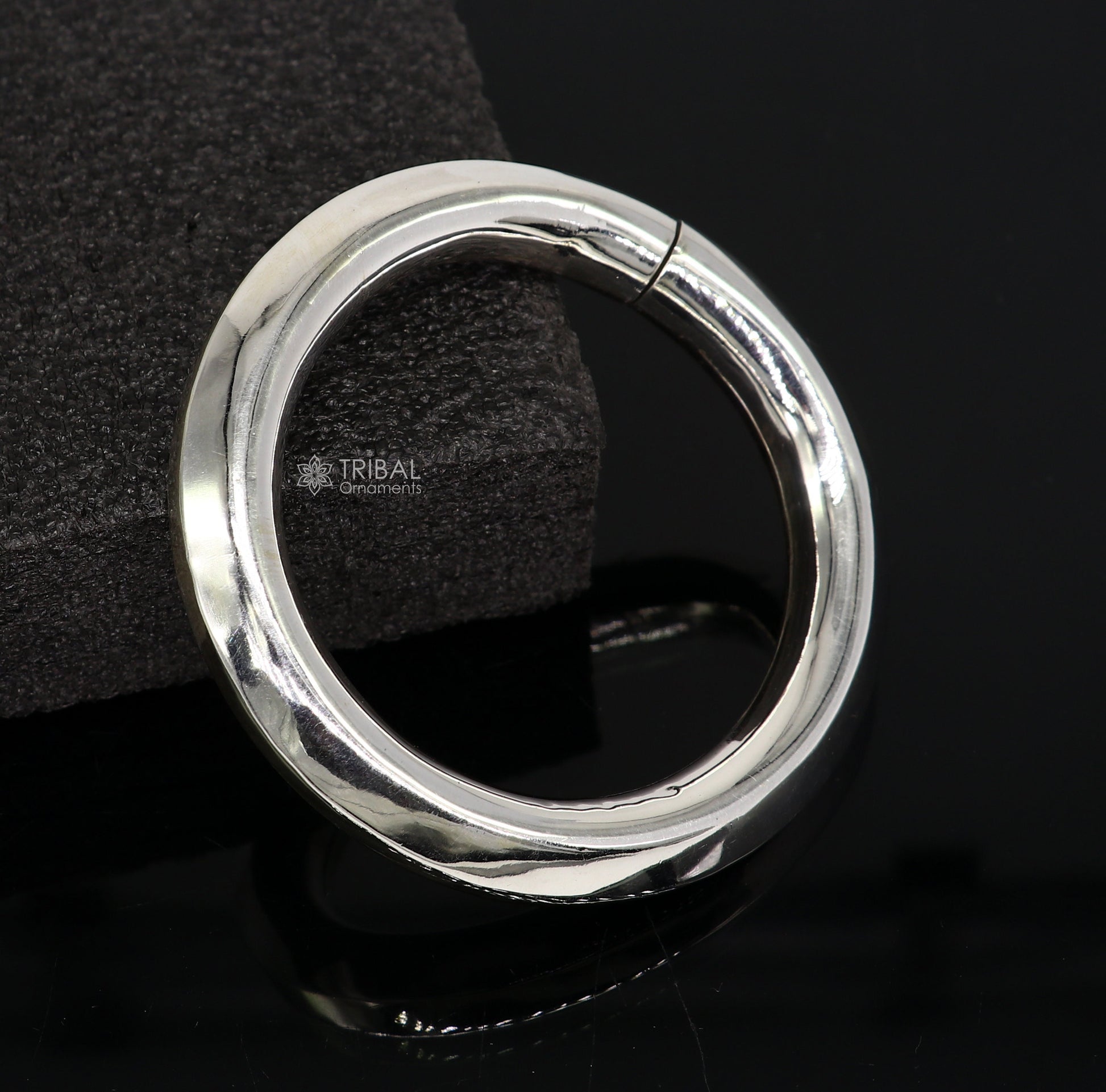 Sterling silver 12mm shine bright bangle bracelet by TRIBAL ORNAMENTS, unisex handmade jewelry with a smooth, polished finish.
