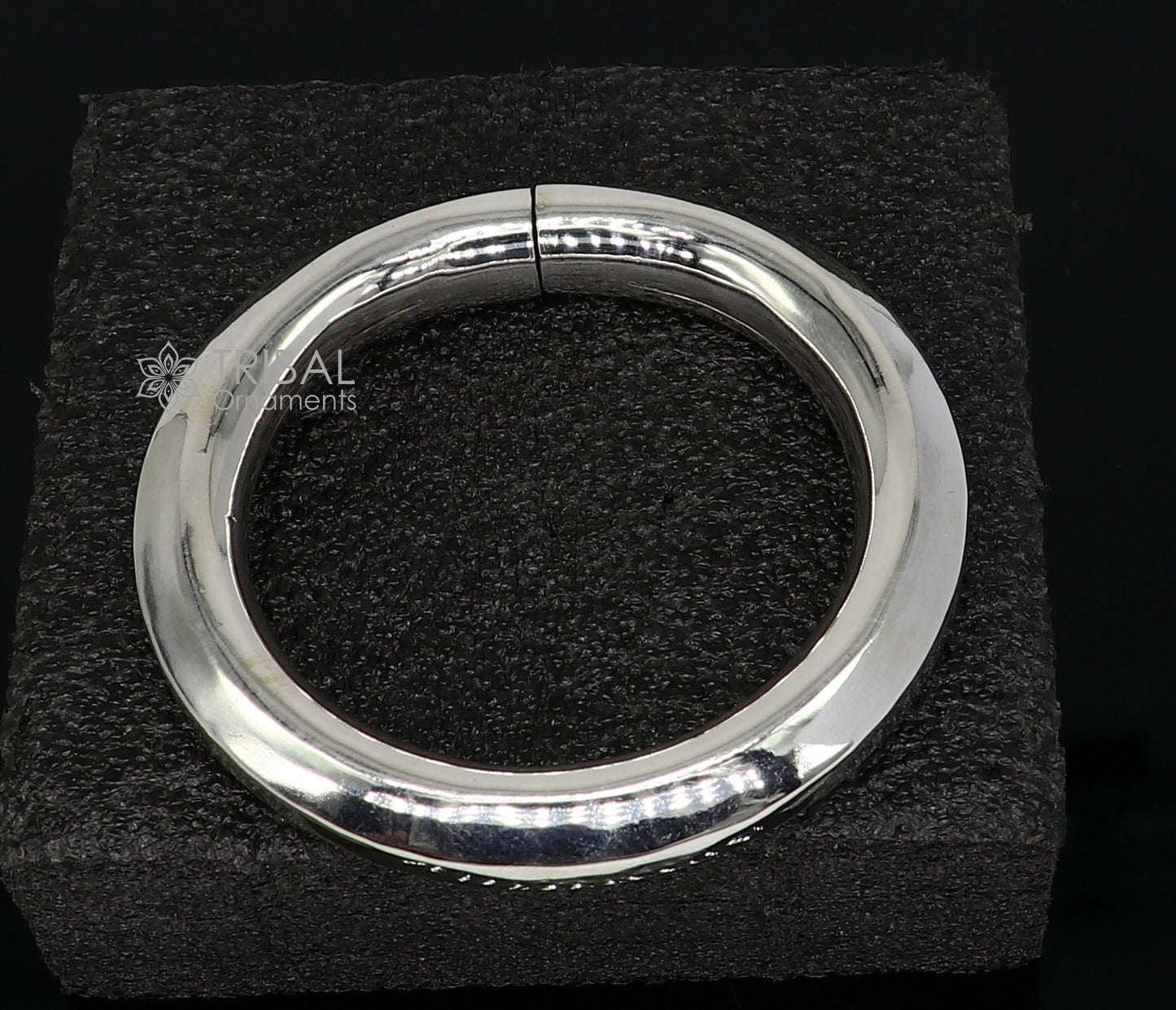 Sterling silver 12mm shine bright bangle bracelet by TRIBAL ORNAMENTS, handcrafted unisex jewelry with a smooth, polished finish.