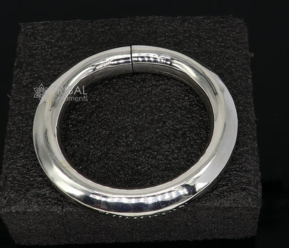 Sterling silver 12mm shine bright bangle bracelet by TRIBAL ORNAMENTS, handcrafted unisex jewelry with a smooth, polished finish.