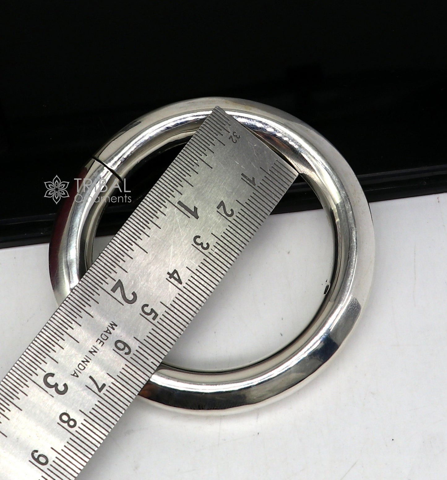 Sterling silver 12mm shine bright bangle bracelet by TRIBAL ORNAMENTS, handmade unisex jewelry with polished finish.