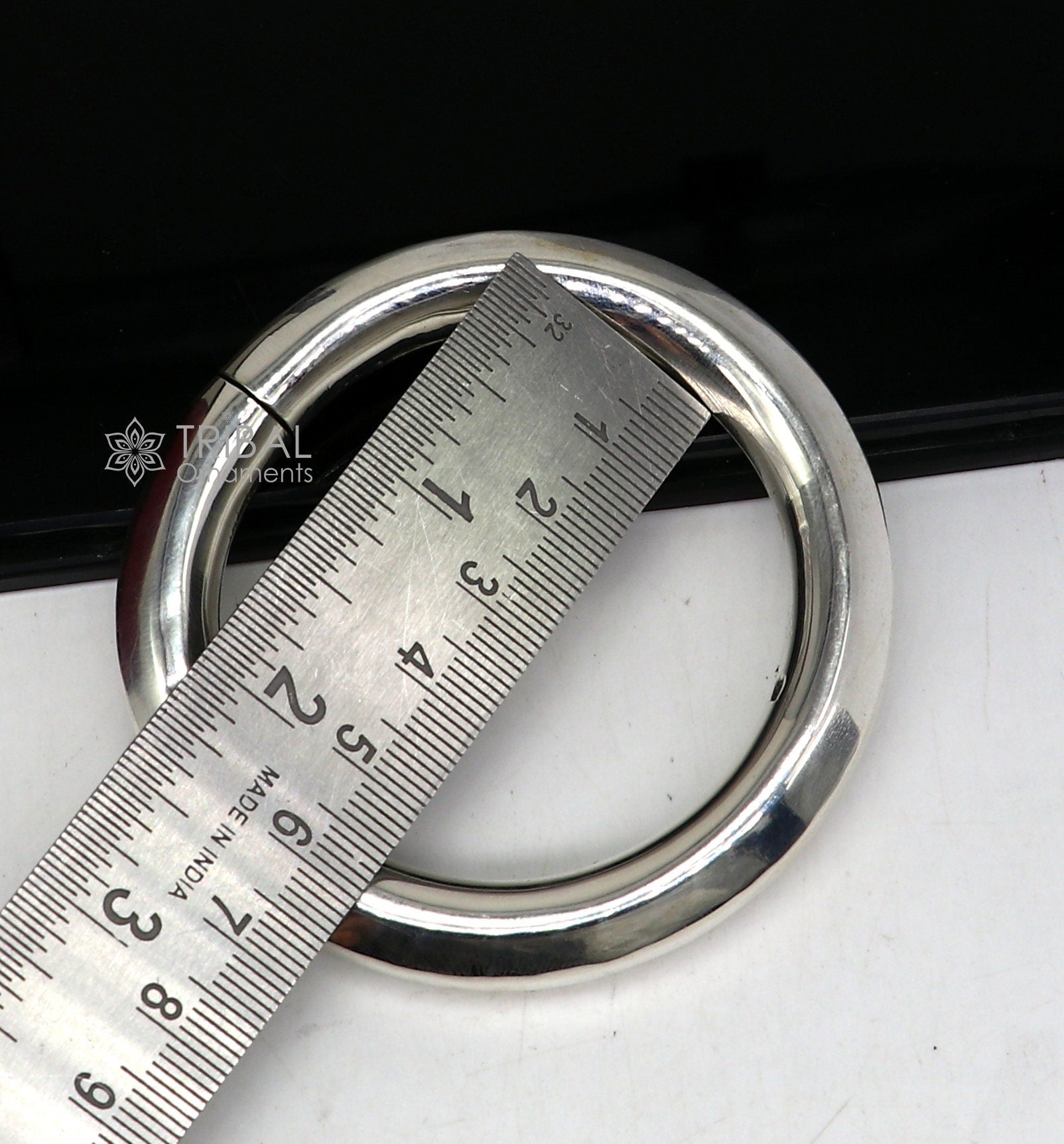 Sterling silver 12mm shine bright bangle bracelet by TRIBAL ORNAMENTS, handmade unisex jewelry with polished finish.