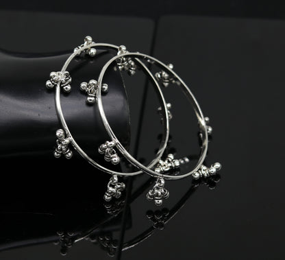 Sterling silver bridesmaid bangle bracelet with hanging bells, handcrafted by TRIBAL ORNAMENTS for personalized wedding jewelry.