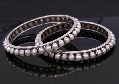 925 sterling silver bangle with a luminous pearl, handmade tribal jewelry for brides, showcasing cultural and functional design.