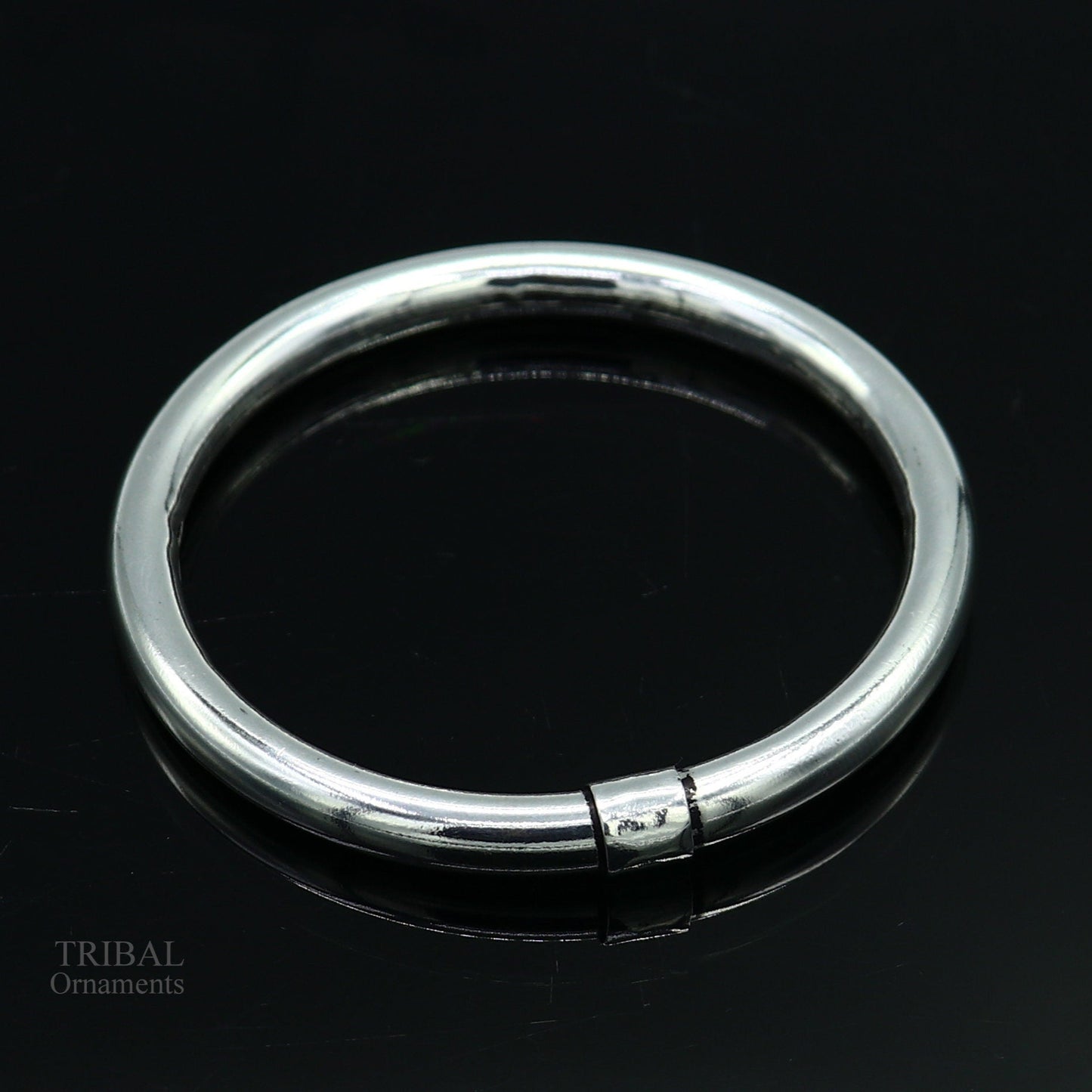 Sterling silver bangle bracelet by Tribal Ornaments, shiny and smooth, stylish kada suitable for men or girls, perfect for personalized gifting.