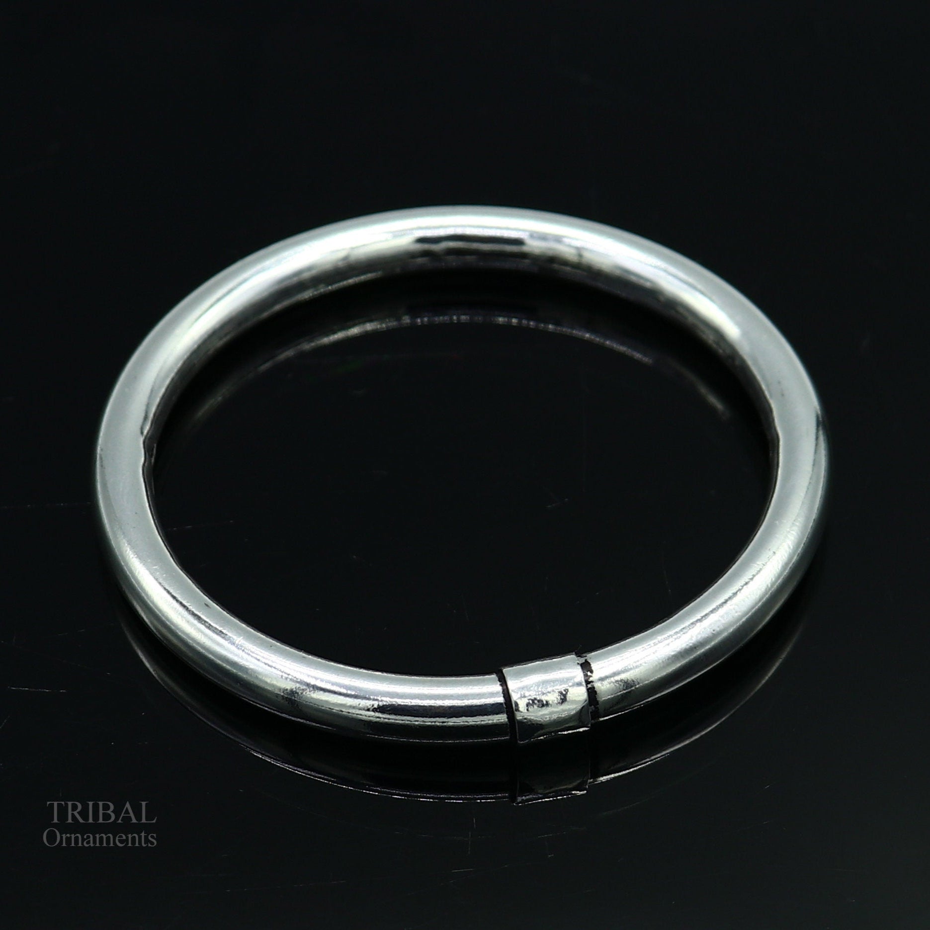 Sterling silver bangle bracelet by Tribal Ornaments, shiny and smooth, stylish kada suitable for men or girls, perfect for personalized gifting.