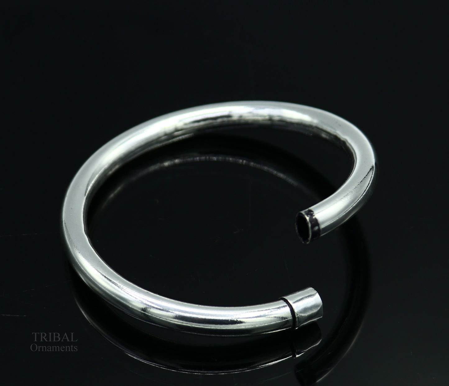 Sterling silver bangle bracelet by TRIBAL ORNAMENTS, shiny and plain, stylish for men or women, perfect for personalized gifting.