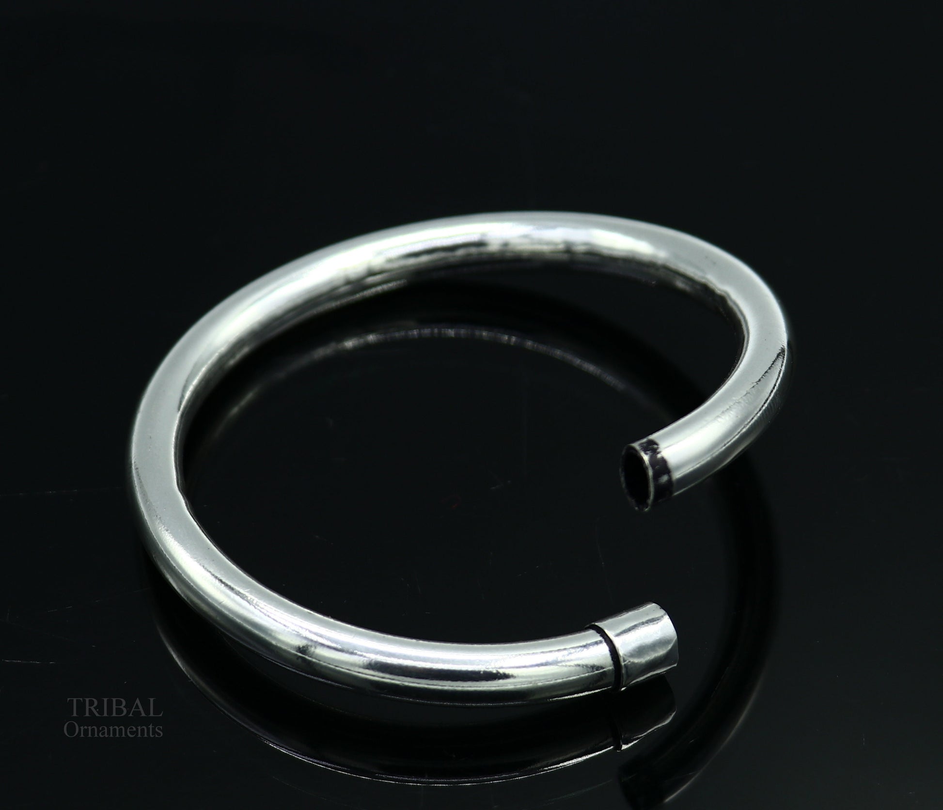 Sterling silver bangle bracelet by TRIBAL ORNAMENTS, shiny and plain, stylish for men or women, perfect for personalized gifting.