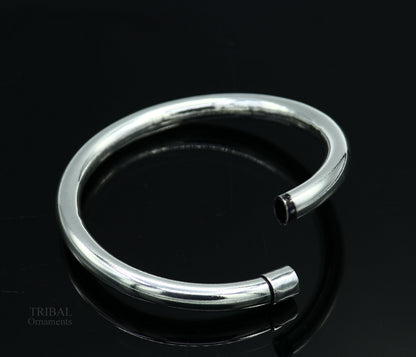 Sterling silver bangle bracelet by TRIBAL ORNAMENTS, shiny and plain, stylish for men or women, perfect for personalized gifting.