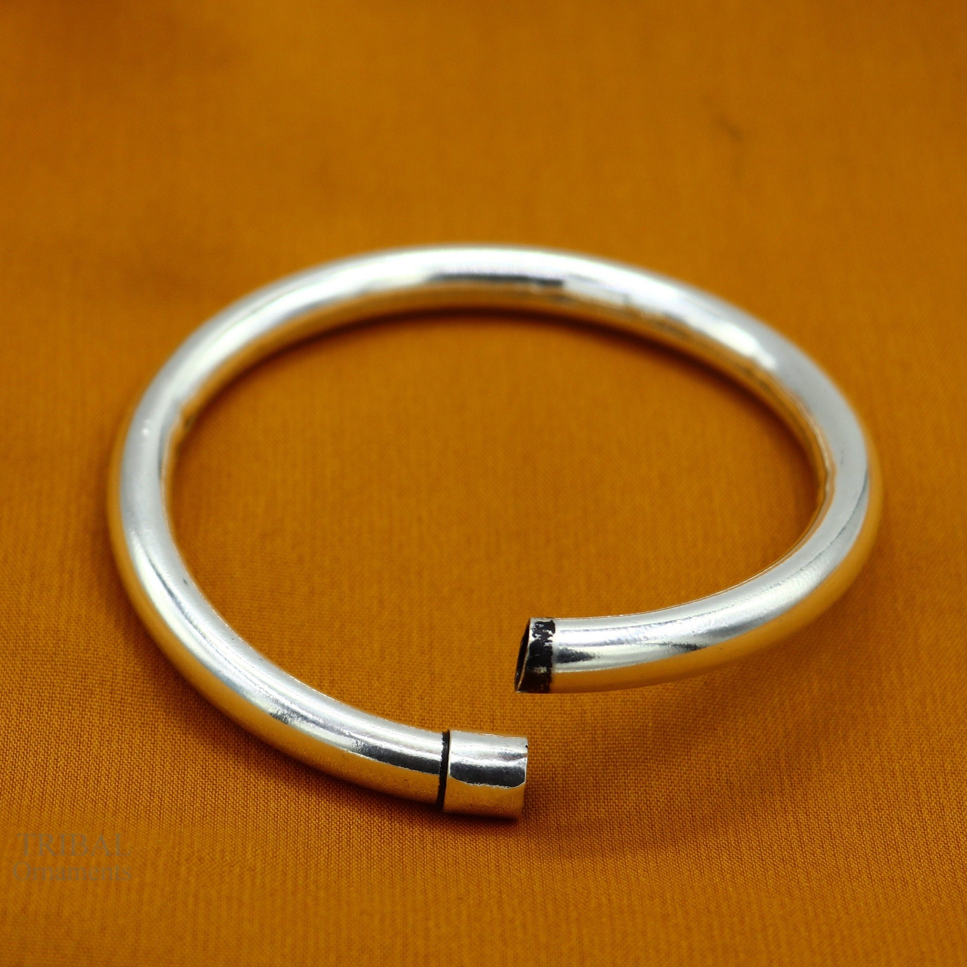 Sterling silver bangle bracelet by Tribal Ornaments, shiny and stylish plain kada for men or girls, ideal for personalized gifting.
