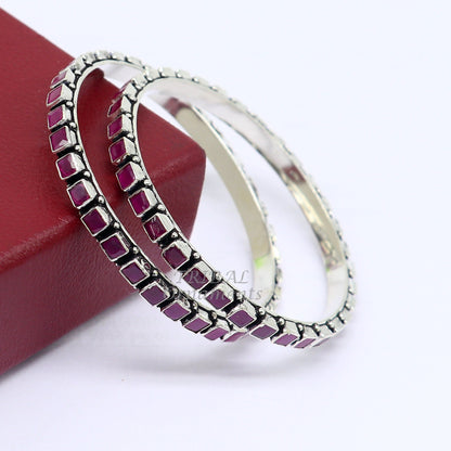 Sterling silver bangle bracelet with a red cut stone, featuring intricate tribal design, suitable for girls and women.