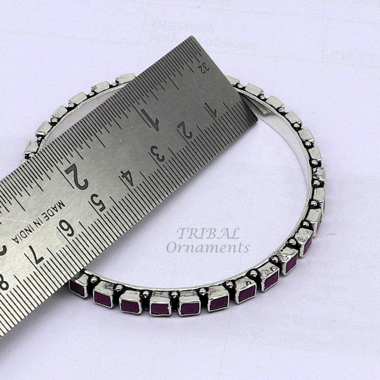 Sterling silver bangle bracelet with a vibrant red cut stone, stylish jewelry for women and girls from Tribal Ornaments.