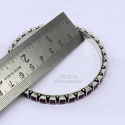 Sterling silver bangle bracelet with a vibrant red cut stone, stylish jewelry for women and girls from Tribal Ornaments.