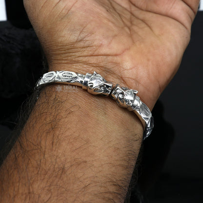 Sterling silver lion face design handcrafted bangle bracelet by TRIBAL ORNAMENTS, unisex jewelry with detailed lion motif.