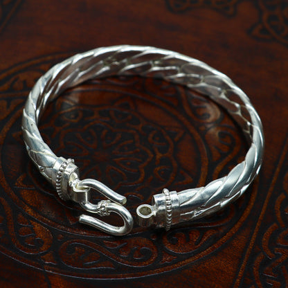 Sterling silver handmade bangle bracelet by TRIBAL ORNAMENTS, bright shining unisex jewelry with intricate design, perfect for gifting.