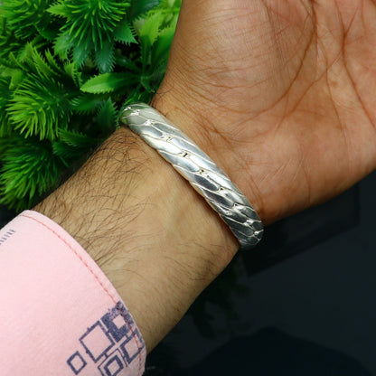 Sterling silver handmade bangle bracelet by Tribal Ornaments, shiny unisex jewelry with intricate designs, perfect for gifting or personal style.
