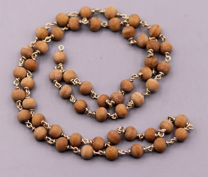 Handmade sandal chandan wood Jaap mala with 925 silver chain, used for prayer, featuring traditional Indian bead design.