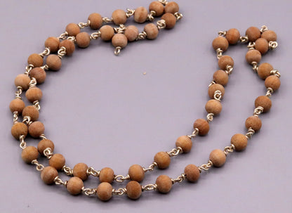 Handmade sandal chandan wood Jaap mala with 925 silver chain, used for prayer, featuring natural beads and intricate craftsmanship.
