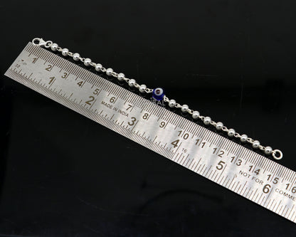 Sterling silver evil eye beaded bracelet or anklet for girls and kids, featuring blue glass evil eye beads and silver beads.