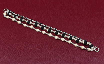 Sterling silver handmade 3-line bracelet featuring black and white tulsi plant wood beads by Tribal Ornaments.