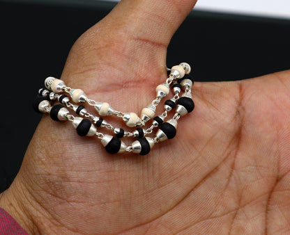 Black and white tulsi plant wood beaded sterling silver handmade 3-line bracelet from Tribal Ornaments, showcasing intricate jewelry craftsmanship.