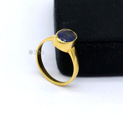 Handmade 22KT yellow gold unisex ring with a blue sapphire Neelam stone, featuring intricate tribal design from Rajasthan, India.