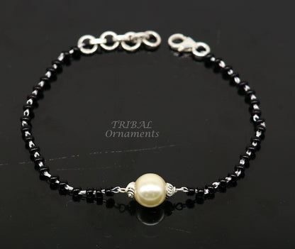 Sterling silver Nazariya bracelet with black beads, stylish jewelry designed to protect from evil eyes, by TRIBAL ORNAMENTS.