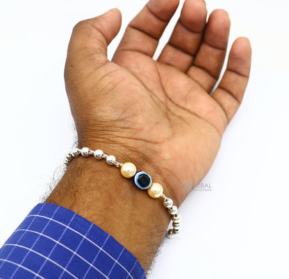Sterling silver handmade evil eye bracelet with silver beads, unisex cultural jewelry by TRIBAL ORNAMENTS, stylish and trendy.