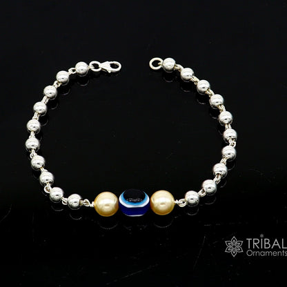 Sterling silver handmade evil eye bracelet with beaded design, unisex cultural jewelry by TRIBAL ORNAMENTS.