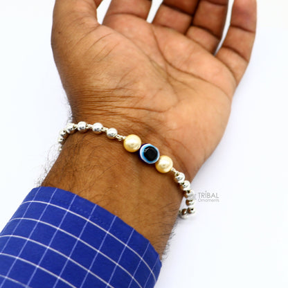 Sterling silver handmade evil eye bracelet with beads, unisex trendy jewelry by TRIBAL ORNAMENTS, showcasing cultural design.