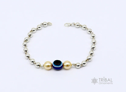 Sterling silver handmade evil eye bracelet with beaded design, unisex cultural jewelry by TRIBAL ORNAMENTS.