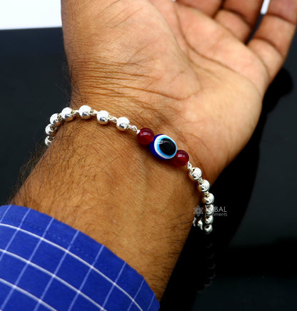 Unisex 925 sterling silver handmade evil eye beaded bracelet with intricate silver beads, tribal-inspired jewelry design.
