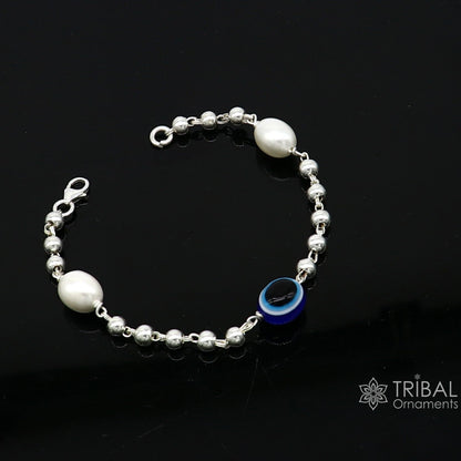 Sterling silver handmade evil eye bracelet with beaded design, unisex jewelry by TRIBAL ORNAMENTS, stylish and cultural accessory.