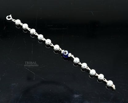 Sterling silver beaded evil eye bracelet by TRIBAL ORNAMENTS, stylish unisex kids jewelry with handmade beads and protective eye design.