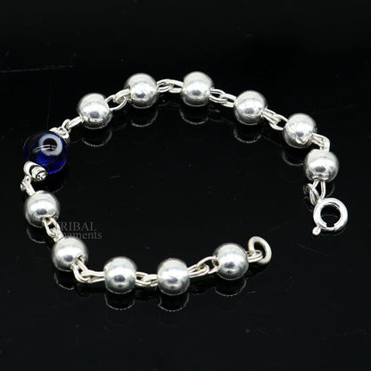 Sterling silver beaded evil eye bracelet by Tribal Ornaments, stylish unisex kids jewelry with intricate handmade bead design.