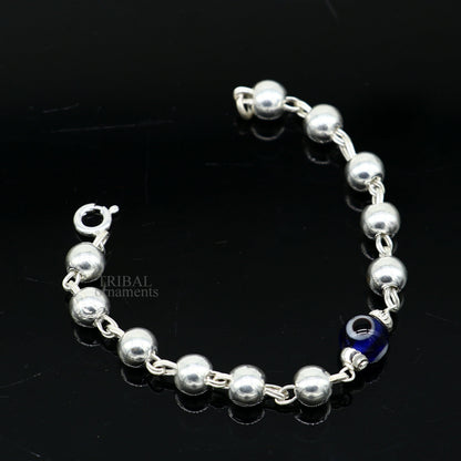 Sterling silver beaded evil eye bracelet by TRIBAL ORNAMENTS, stylish unisex kids jewelry with blue evil eye charm and handmade design.