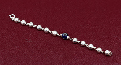 Sterling silver beaded evil eye bracelet by TRIBAL ORNAMENTS, stylish unisex kids jewelry with intricate beaded design and evil eye charm.