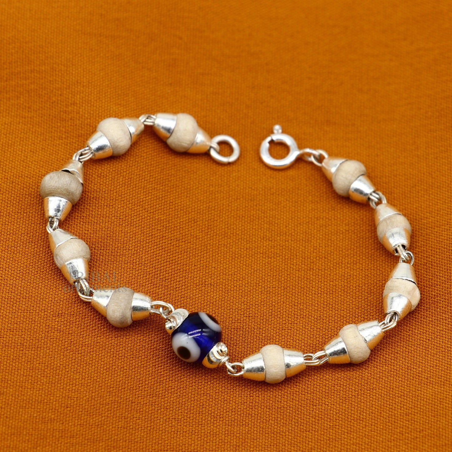 Sterling silver handmade baby Tulsi bracelet with evil eye beads, stylish unisex design by TRIBAL ORNAMENTS.