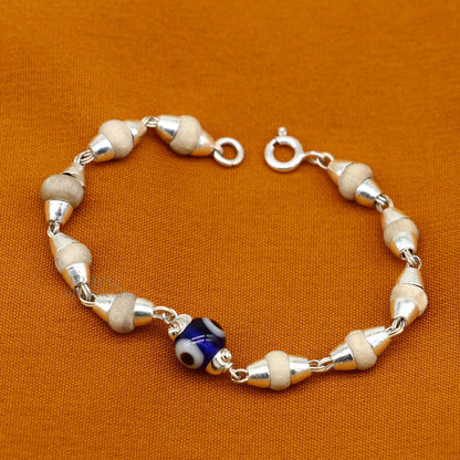 Sterling silver handmade baby Tulsi bracelet with evil eye beads, stylish unisex design by TRIBAL ORNAMENTS.