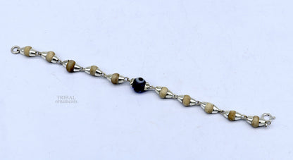 Sterling silver handmade baby Tulsi bracelet by TRIBAL ORNAMENTS with evil eye beads, stylish unisex jewelry for protection and style