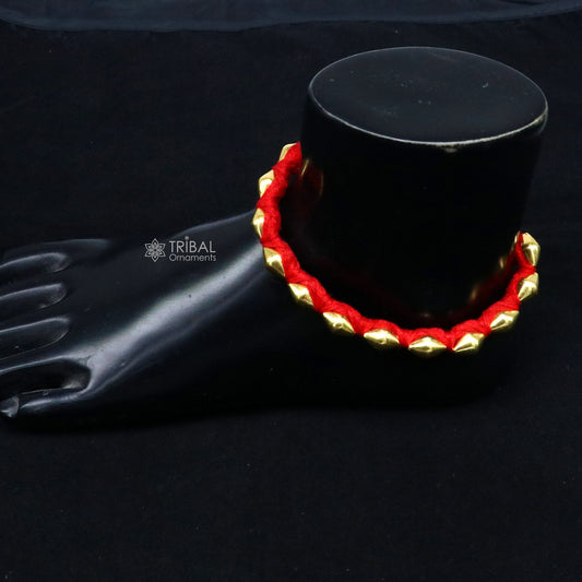 22KT yellow gold handmade dholki beads oval bracelet or anklet by TRIBAL ORNAMENTS, with custom thread and tribal ethnic design.