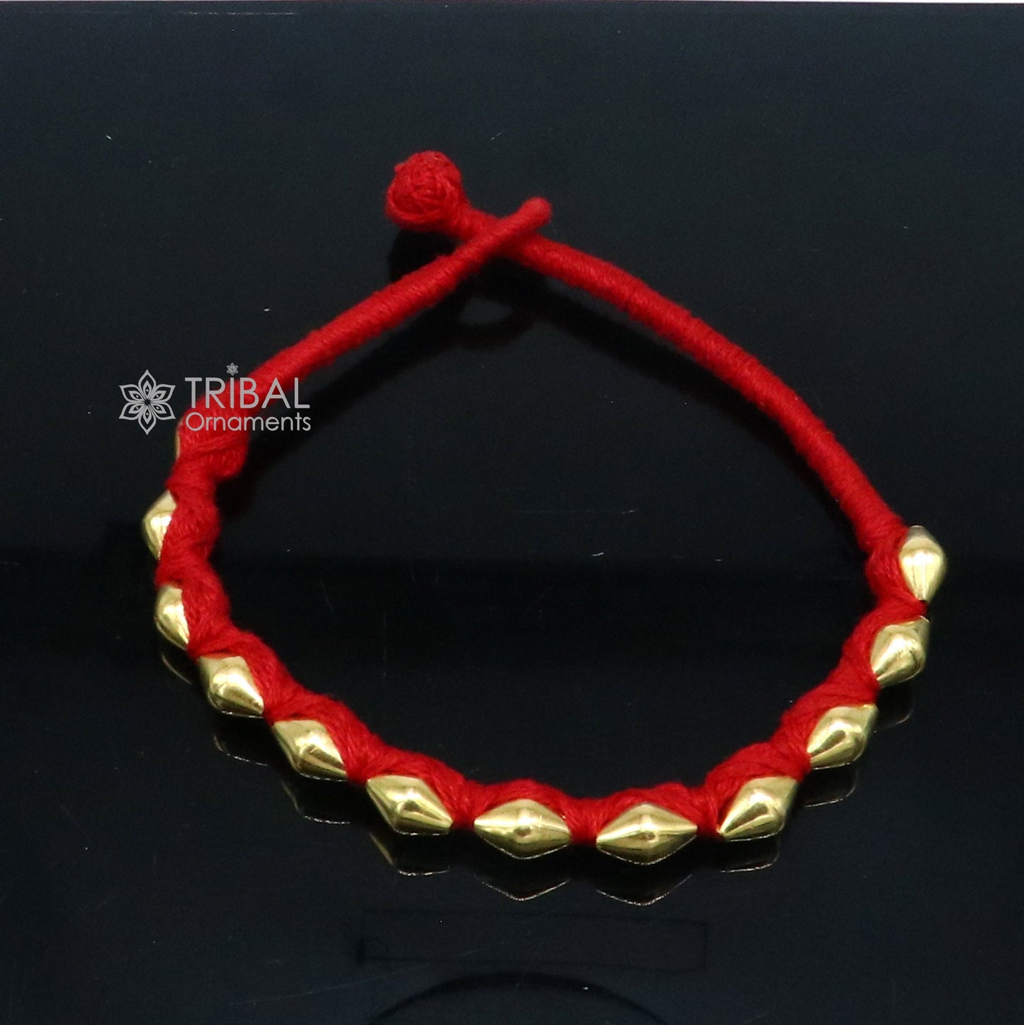 22KT yellow gold handmade dholki beads oval-shaped bracelet or anklet by TRIBAL ORNAMENTS, with custom thread ethnic tribal jewelry.