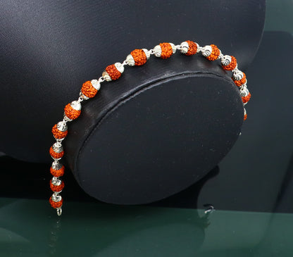 Solid silver handmade bracelet with 6mm natural Rudraksha beads, crafted by TRIBAL ORNAMENTS from Rajasthan, India.
