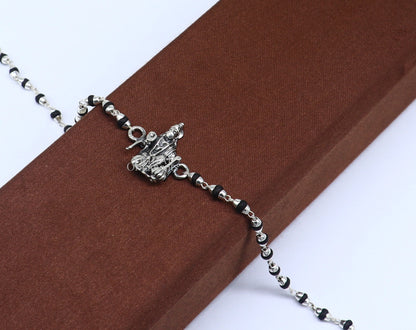 Sterling silver Hanuman design black tulsi beads bracelet from TRIBAL ORNAMENTS, customized beaded rakhi for special occasions.