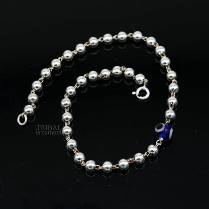 Sterling silver handmade beaded evil eye bracelet by TRIBAL ORNAMENTS, stylish unisex jewelry with intricate beaded design.
