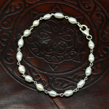 Sterling silver beaded bracelet with natural pearl accents, handmade unisex jewelry by Tribal Ornaments, perfect for gifting.