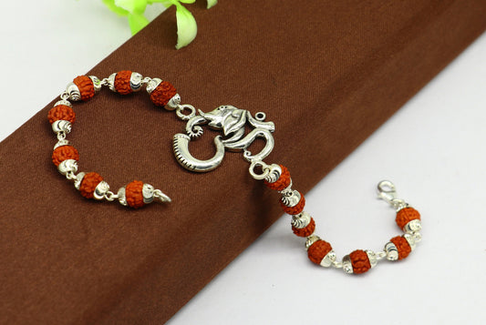 925 Sterling silver OM Rudraksha bead bracelet from TRIBAL ORNAMENTS, custom beaded Aum design with intricate details.