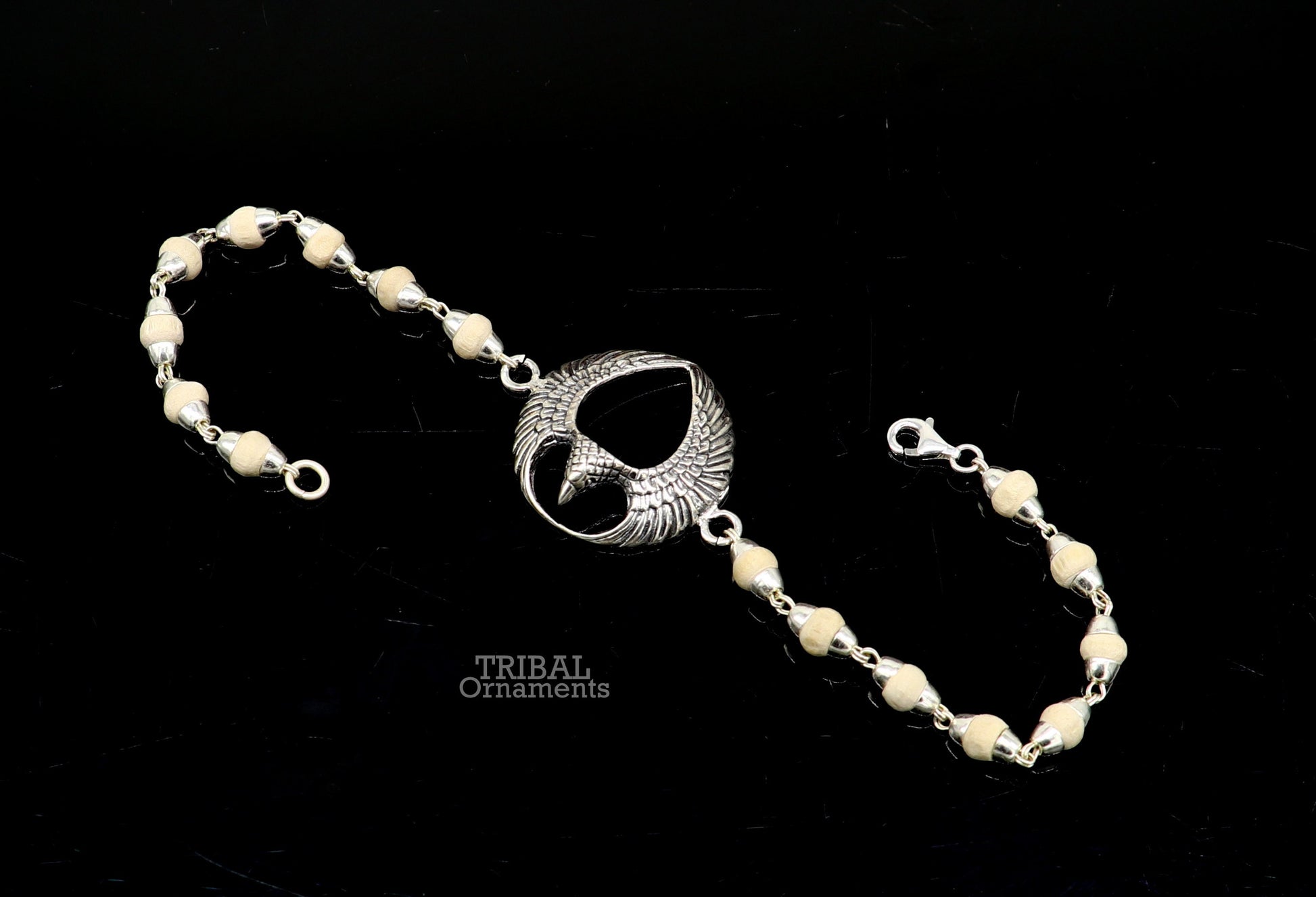 925 sterling silver Lord Garuda Tulsi beaded bracelet rakhi by TRIBAL ORNAMENTS featuring black basil beads and intricate Garuda design.